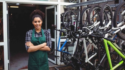 Smiling mechanic standing with arms crossed