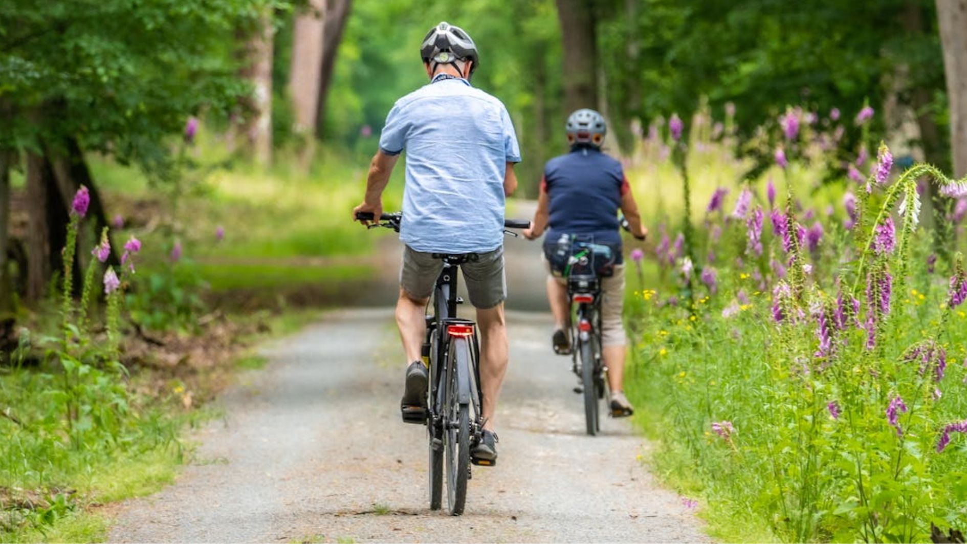 People Riding Bicycles on Dirt Road