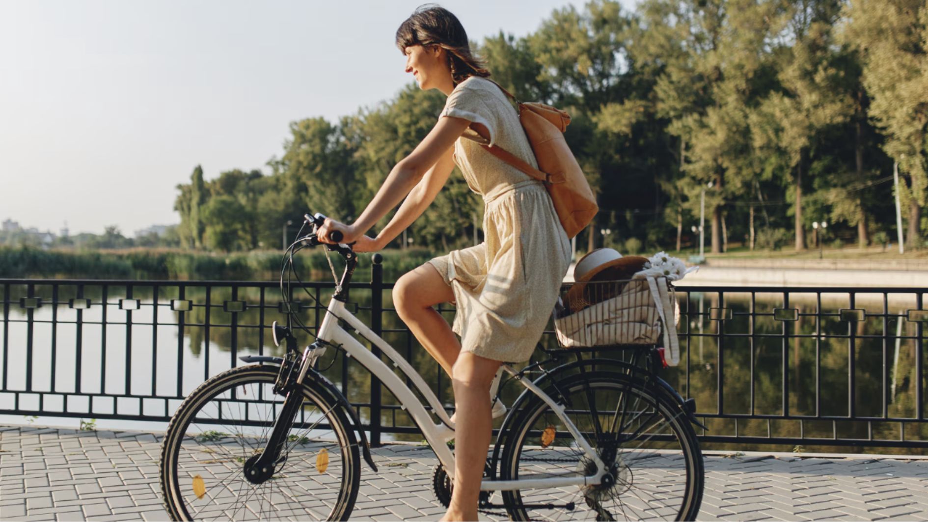 Young woman against nature background with bike